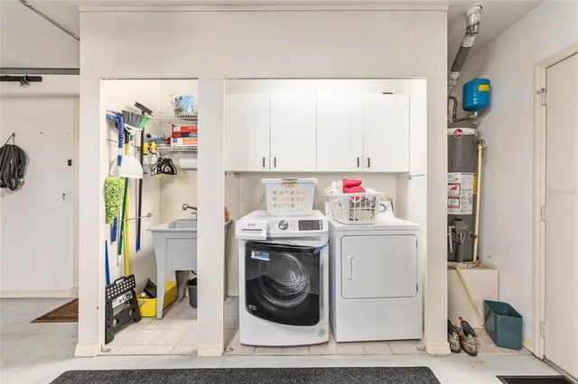 a view of a house with big yard and potted plants