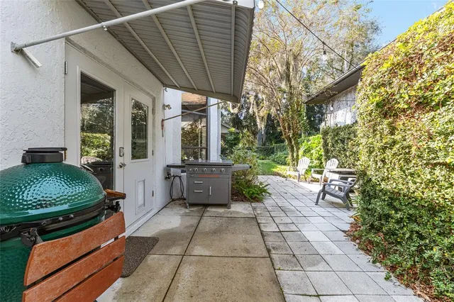 a view of a swimming pool with a yard and plants