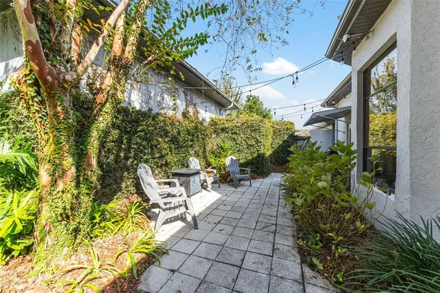 a swimming pool with outdoor seating and yard