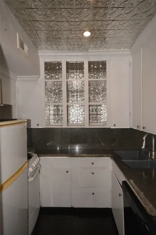 a kitchen with a sink and cabinets