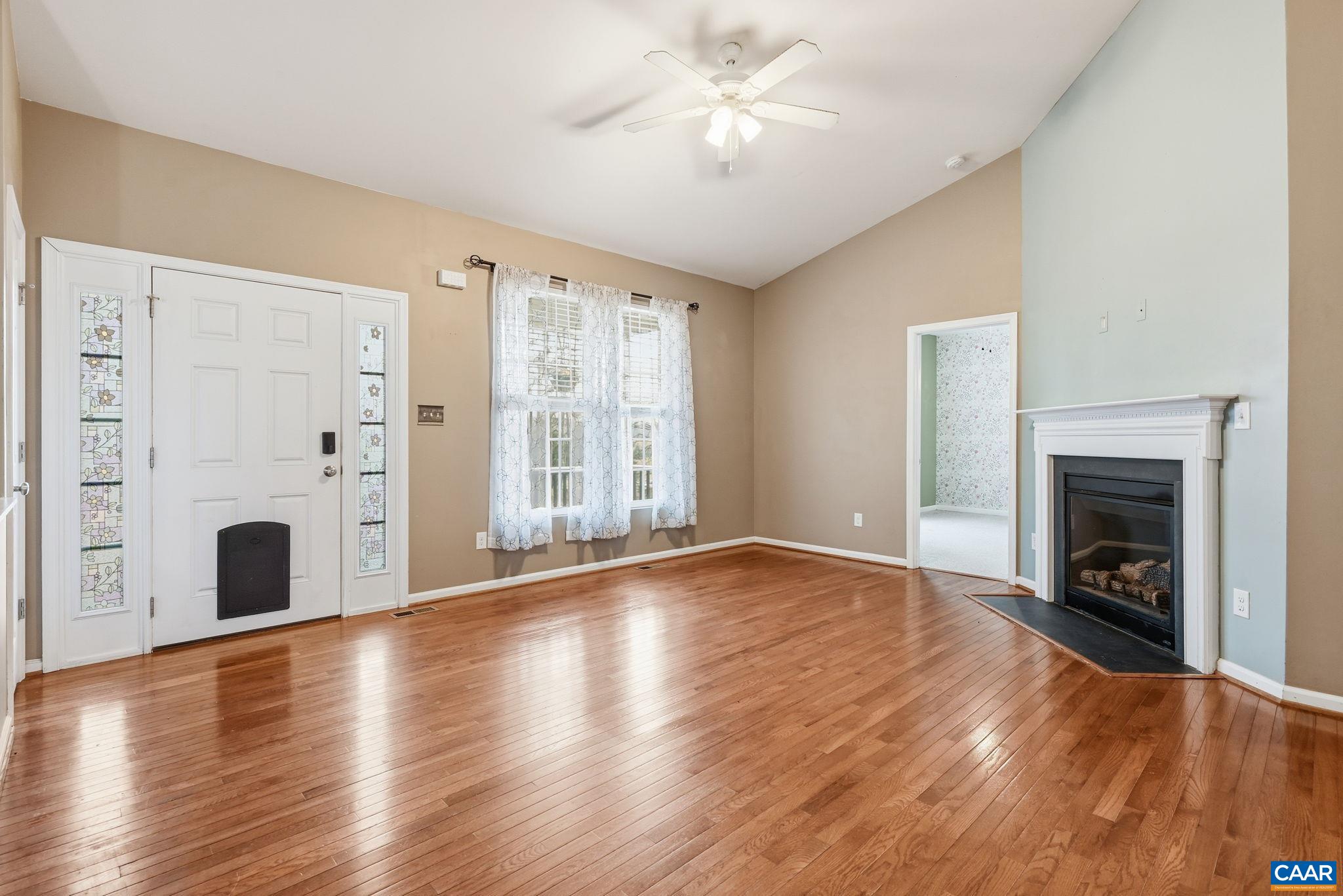2093 Swift Run Road Ruckersville, VA 22968 - Photo 11 of 57 a view of an empty room with wooden floor and a fireplace