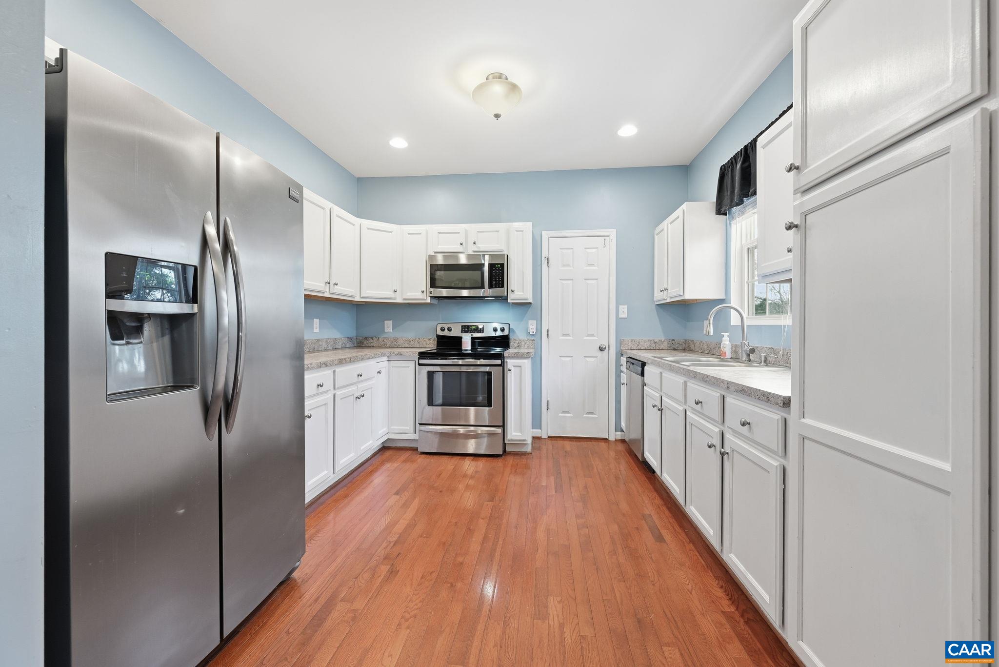 2093 Swift Run Road Ruckersville, VA 22968 - Photo 15 of 57 a kitchen with stainless steel appliances a refrigerator sink and microwave
