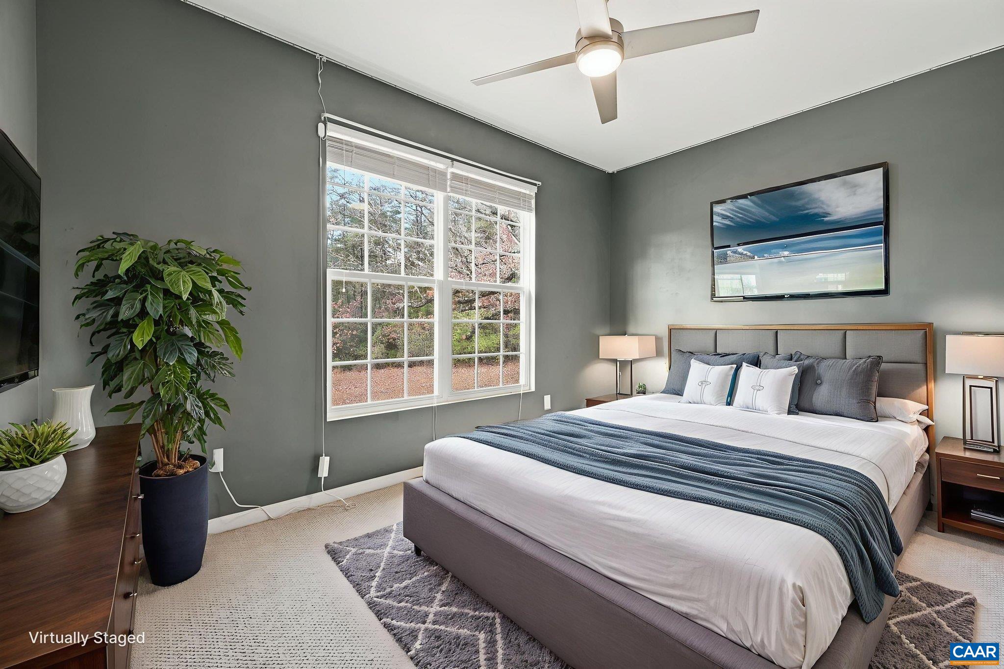 2093 Swift Run Road Ruckersville, VA 22968 - Photo 29 of 57 a bedroom with a large bed and a potted plant