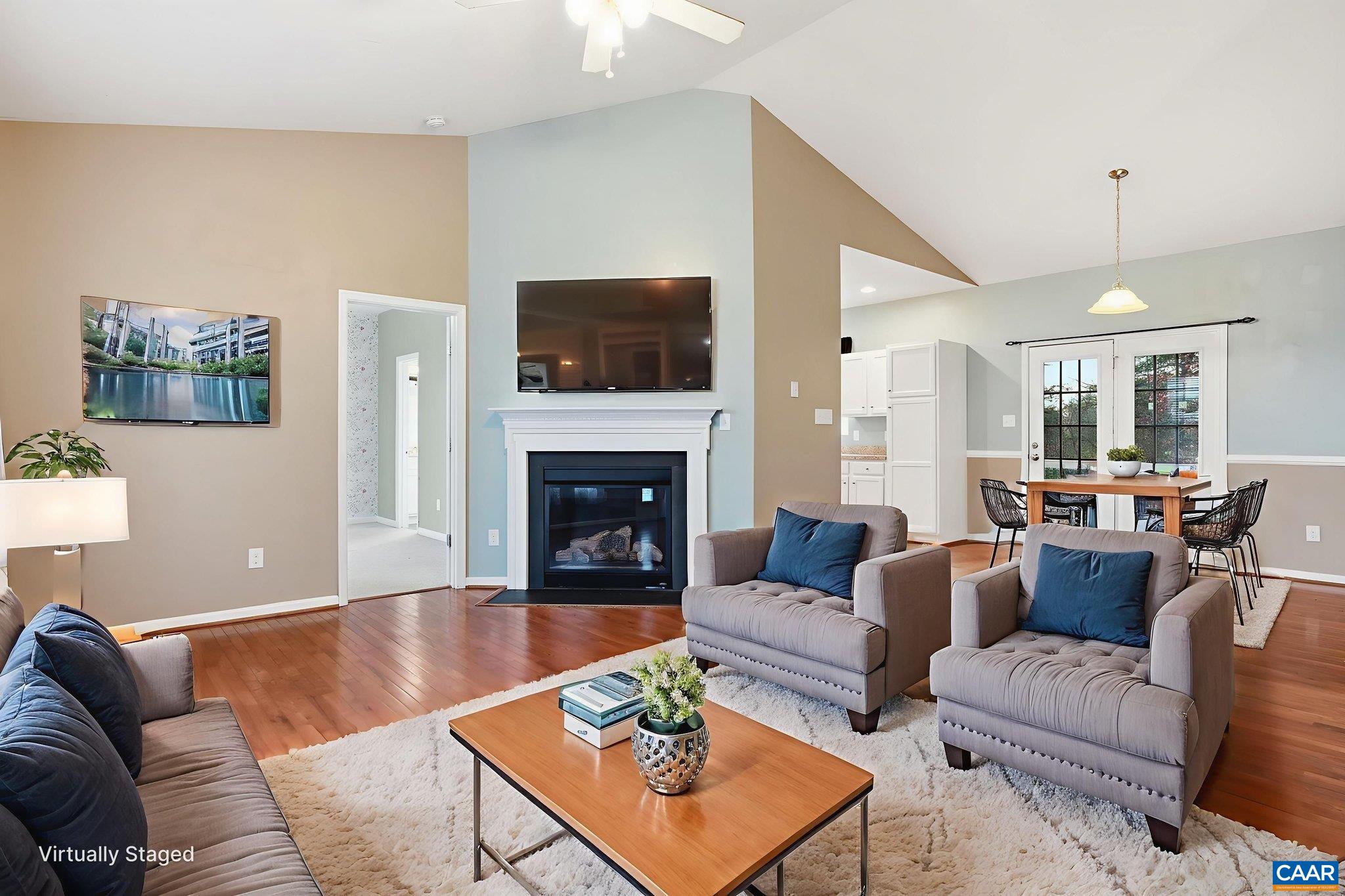 2093 Swift Run Road Ruckersville, VA 22968 - Photo 9 of 57 a living room with furniture a rug a fireplace and a flat screen tv