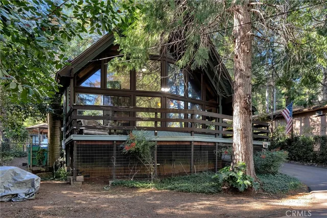a view of house with deck and outdoor seating