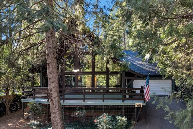 a view of a balcony with chairs and wooden floor
