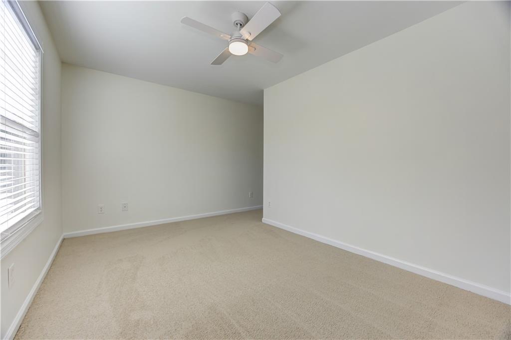 605 Summit Point Canton, GA 30114 - Photo 41 of 56 an empty room with a window and ceiling fan