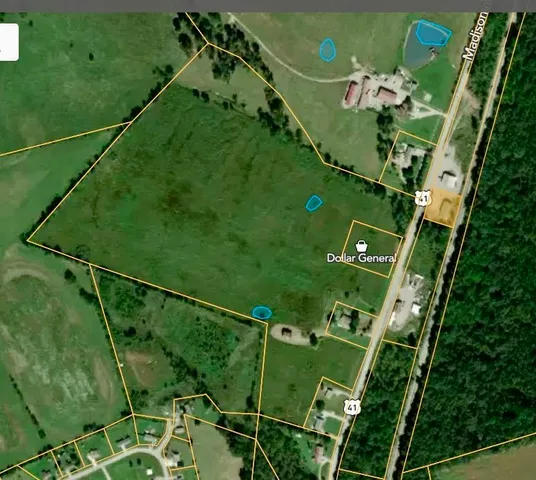 a view of a dry yard with wooden fence