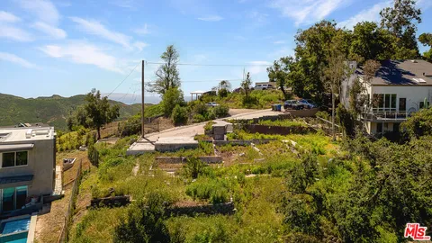 a view of a house with a yard and sitting area