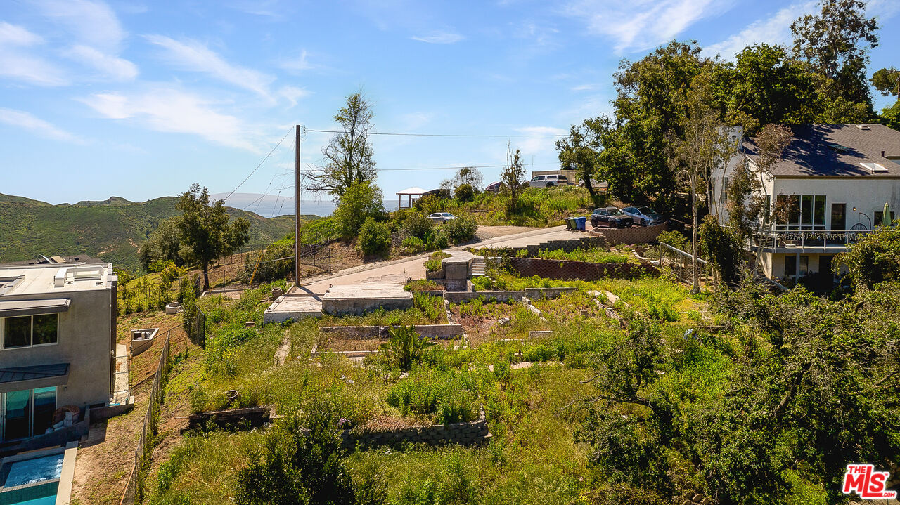 26166 Fairside Road Malibu, CA 90265 - Photo 4 of 7 a view of a house with a yard and sitting area