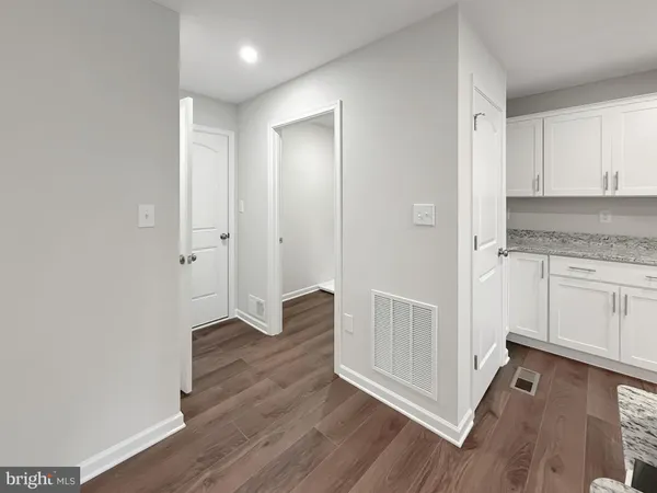 a view of a kitchen with wooden floor