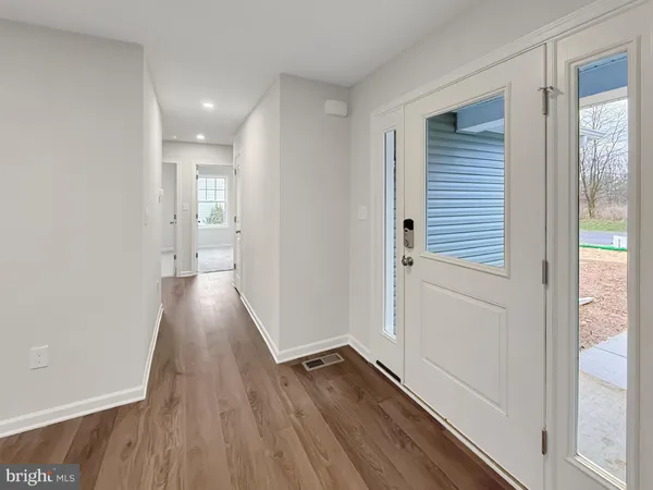 a view of a hallway with wooden floor