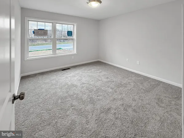 an empty room with a empty space and windows