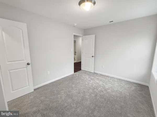 a view of an empty room and a window