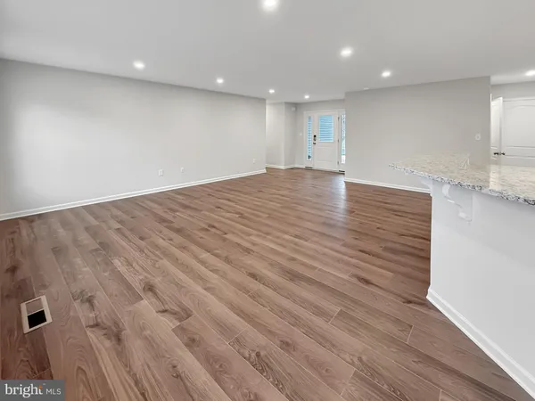 an empty room with wooden floor