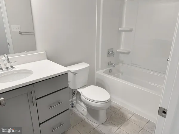 a white toilet sitting next to a bath tub