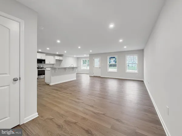 a view of kitchen and hall with wooden floor
