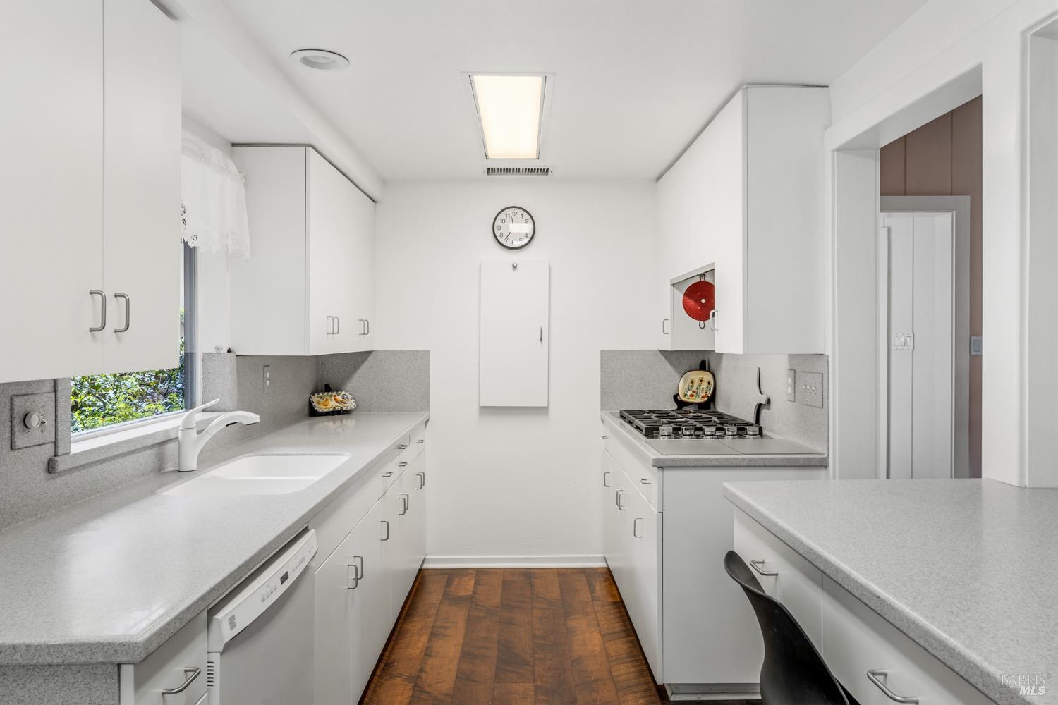 308 Jefferson Lane Ukiah, CA 95482 - Photo 13 of 50 a kitchen with a sink dishwasher stove and white cabinets with wooden floor