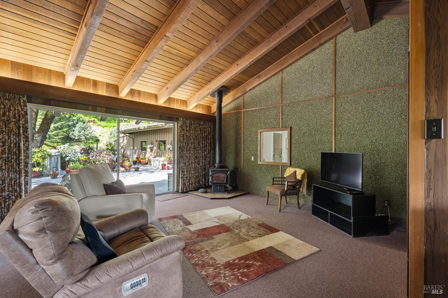 308 Jefferson Lane Ukiah, CA 95482 - Photo 17 of 50 a living room with furniture a flat screen tv and a floor to ceiling window