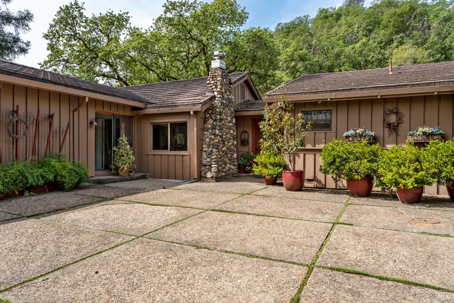 308 Jefferson Lane Ukiah, CA 95482 - Photo 3 of 50 a view of a house with potted plants and a large tree