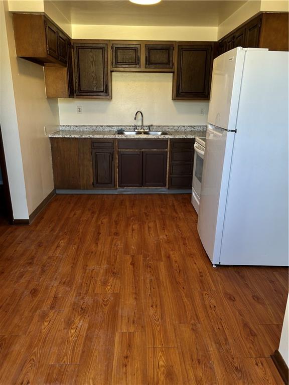 a kitchen with stainless steel appliances a sink and a refrigerator