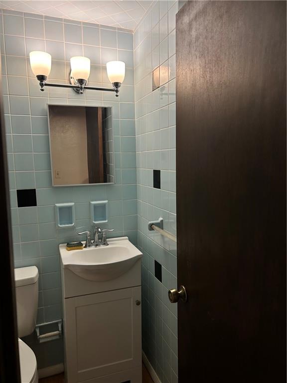 135 Union Street Bridgeville, PA 15017 - Photo 2 of 6 a bathroom with a sink toilet and mirror