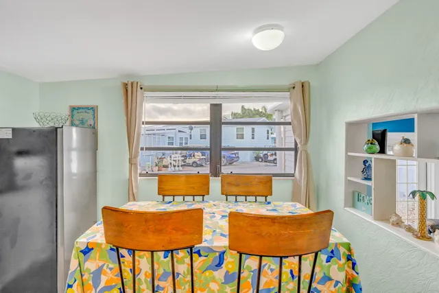 a view of a dining room with furniture and a window