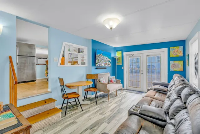 a living room with furniture and a floor to ceiling window