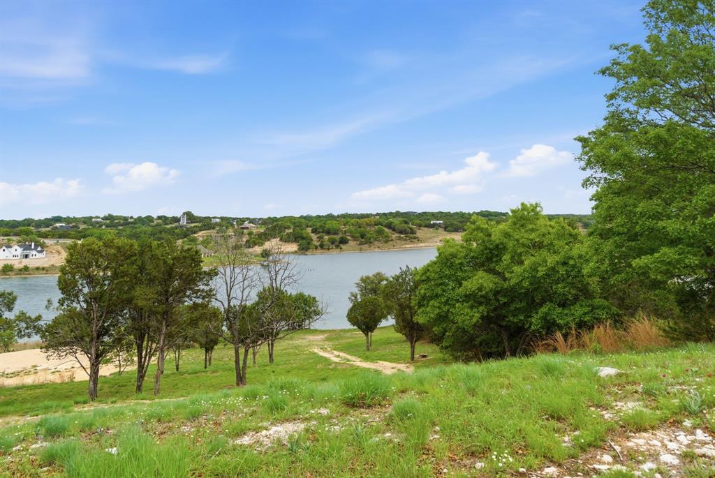 305 Compass Way Bluff Dale Bluff Dale, TX 76433 - Photo 14 of 25 a view of a lake with houses in the back