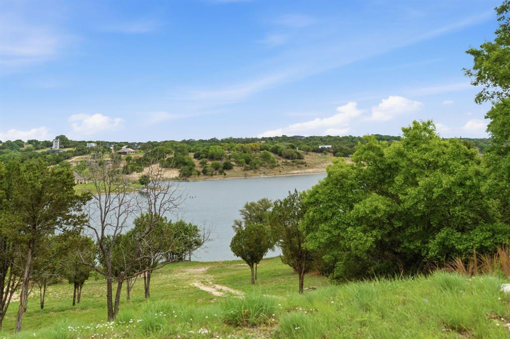305 Compass Way Bluff Dale Bluff Dale, TX 76433 - Photo 16 of 25 a view of lake with houses in the back