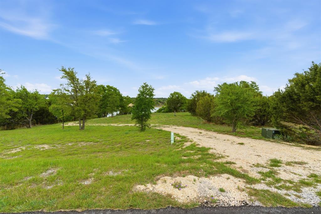 305 Compass Way Bluff Dale Bluff Dale, TX 76433 - Photo 2 of 25 a backyard of a house with lots of green space
