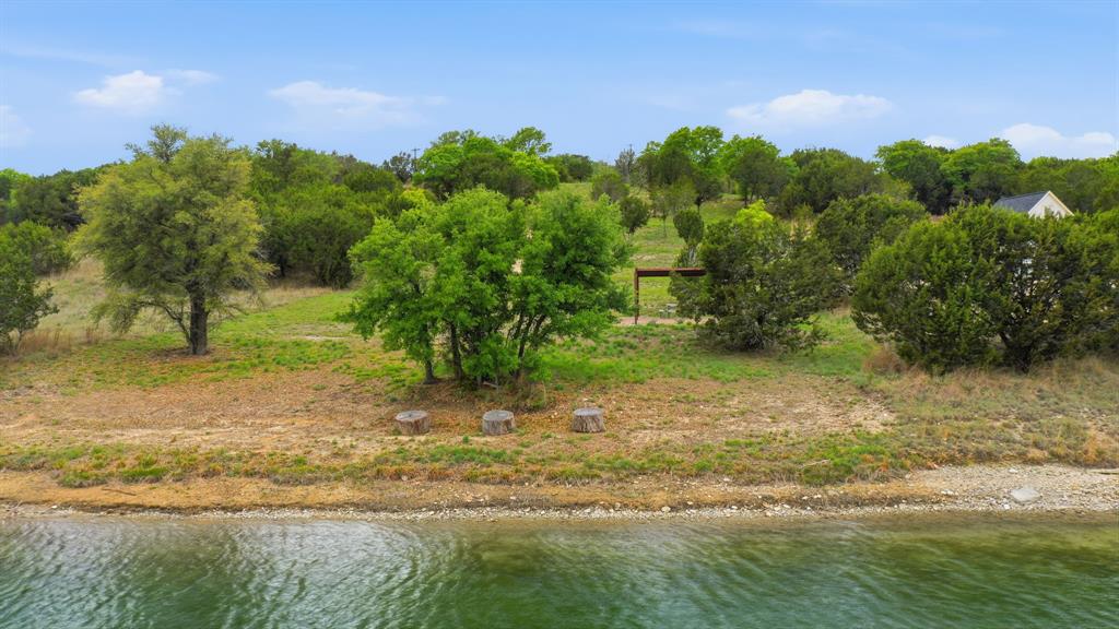 305 Compass Way Bluff Dale Bluff Dale, TX 76433 - Photo 5 of 25 a view of a yard with a tree