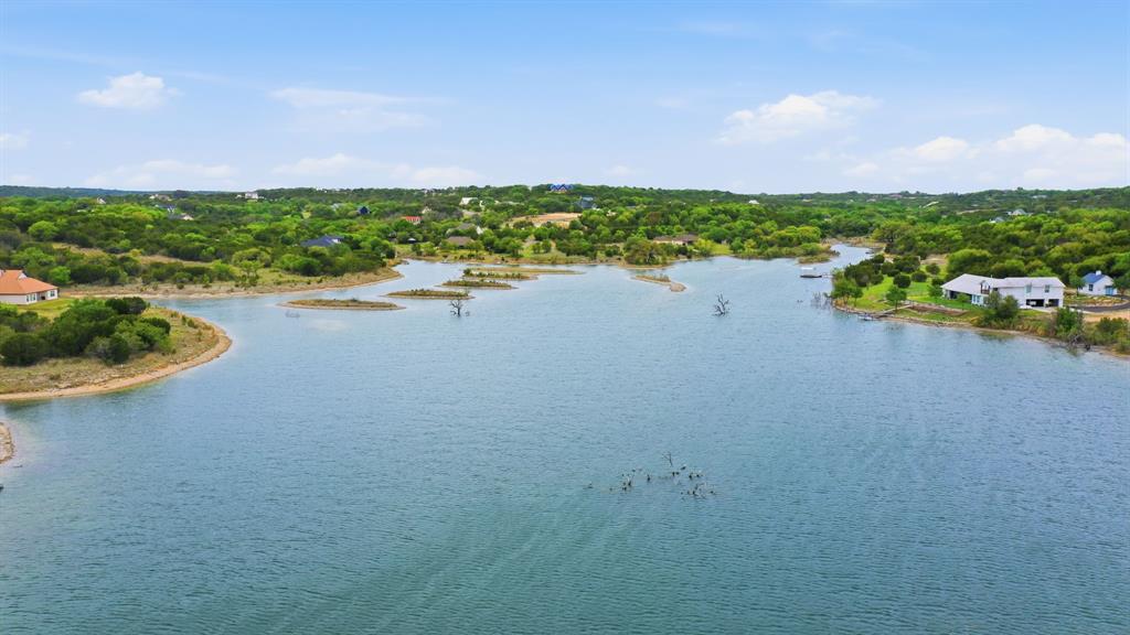 305 Compass Way Bluff Dale Bluff Dale, TX 76433 - Photo 6 of 25 a view of a lake with houses in back