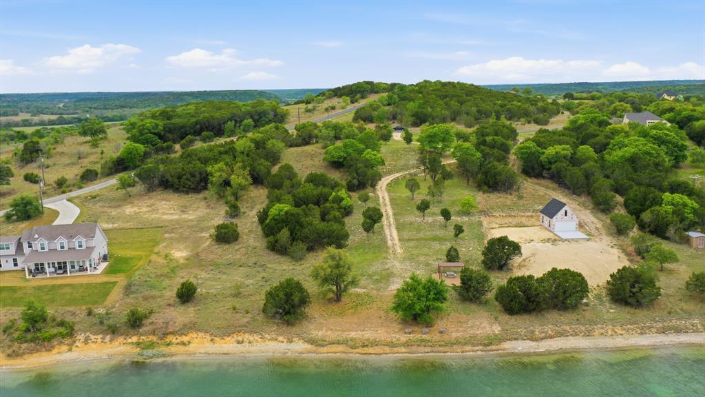 305 Compass Way Bluff Dale Bluff Dale, TX 76433 - Photo 10 of 25 a view of a lake with a mountain in the background