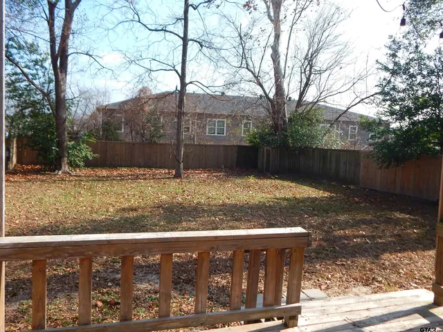 a view of a wooden fence next to a house