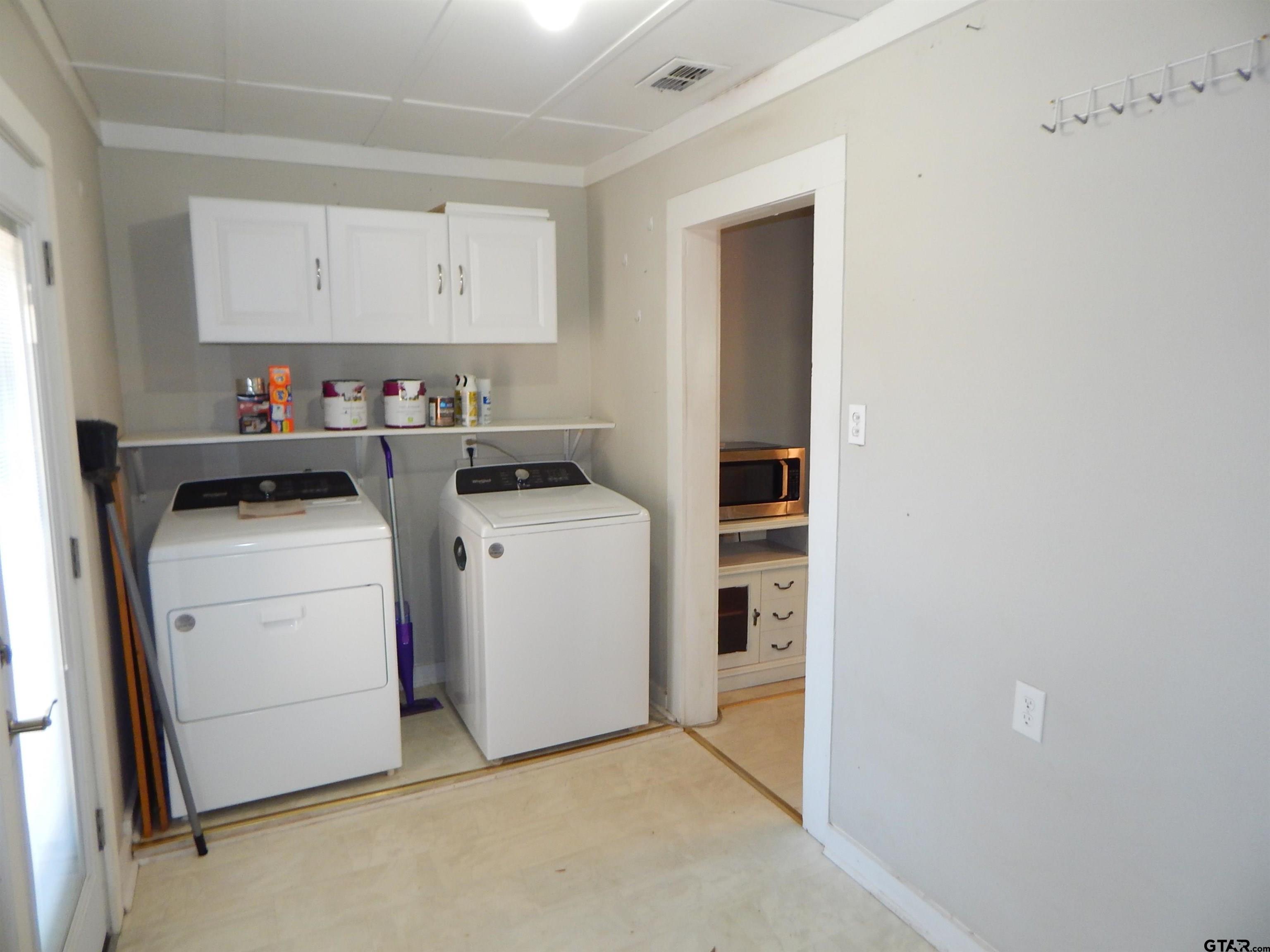 507 North Trinity Street Gilmer, TX 75644 - Photo 29 of 45 a view of storage and utility room with washer and dryer