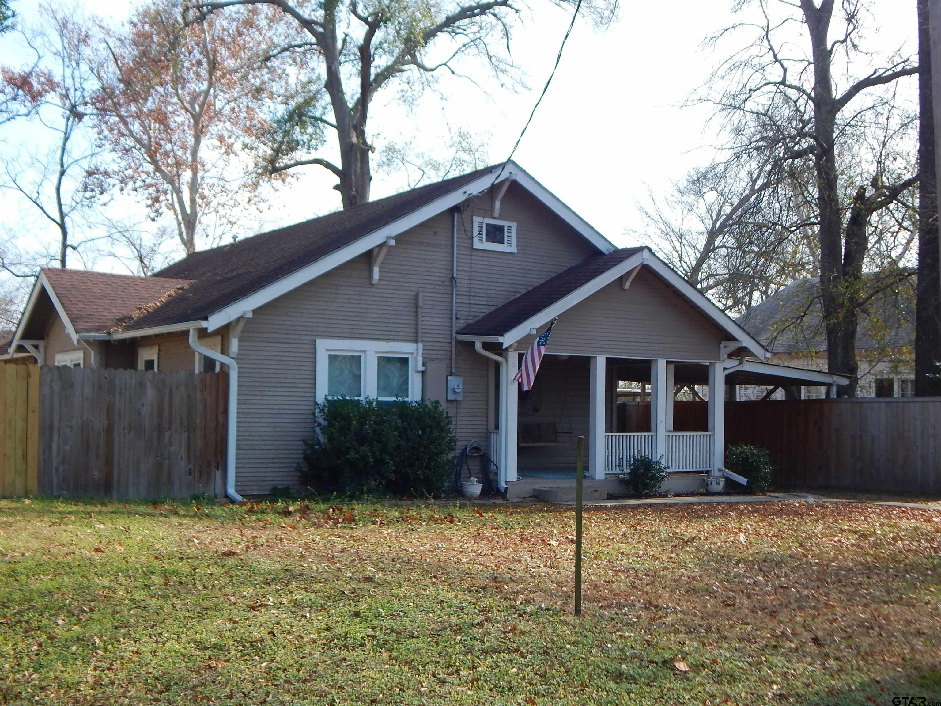 507 North Trinity Street Gilmer, TX 75644 - Photo 3 of 45 a view of a house with a yard and wooden fence