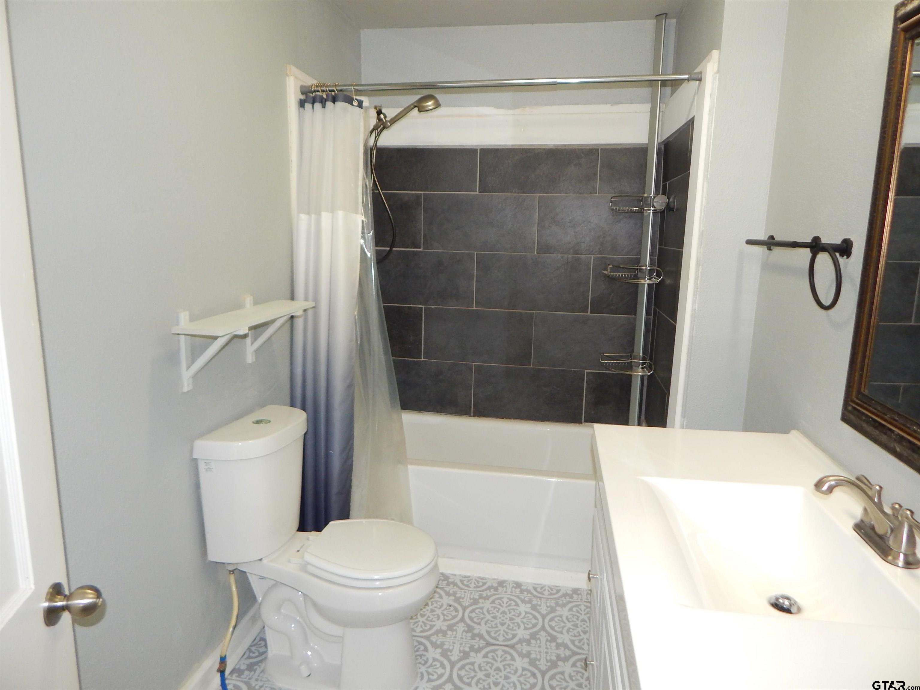 507 North Trinity Street Gilmer, TX 75644 - Photo 33 of 45 a bathroom with a sink toilet and shower