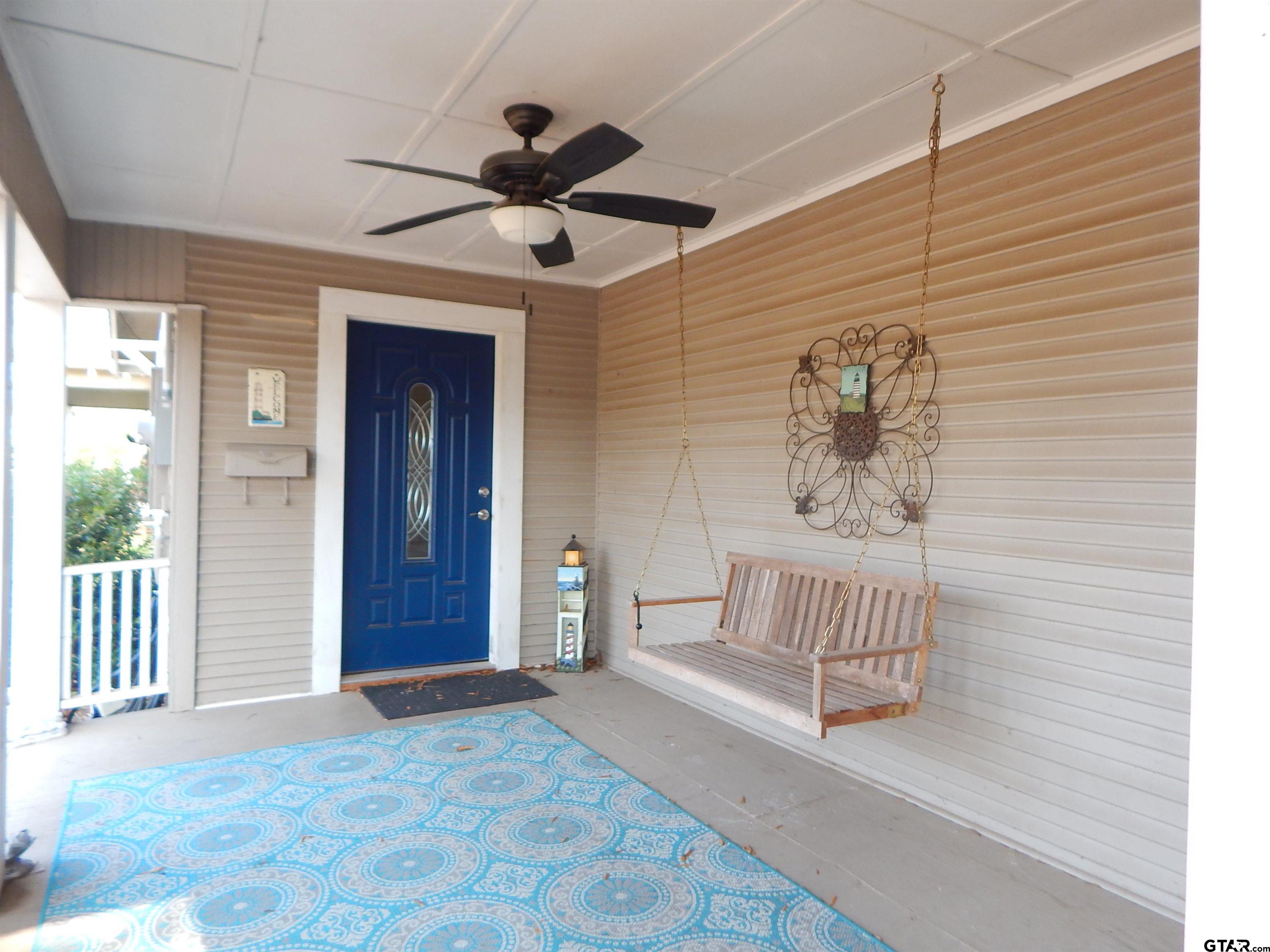 507 North Trinity Street Gilmer, TX 75644 - Photo 4 of 45 a spacious bedroom with a bed and a chandelier