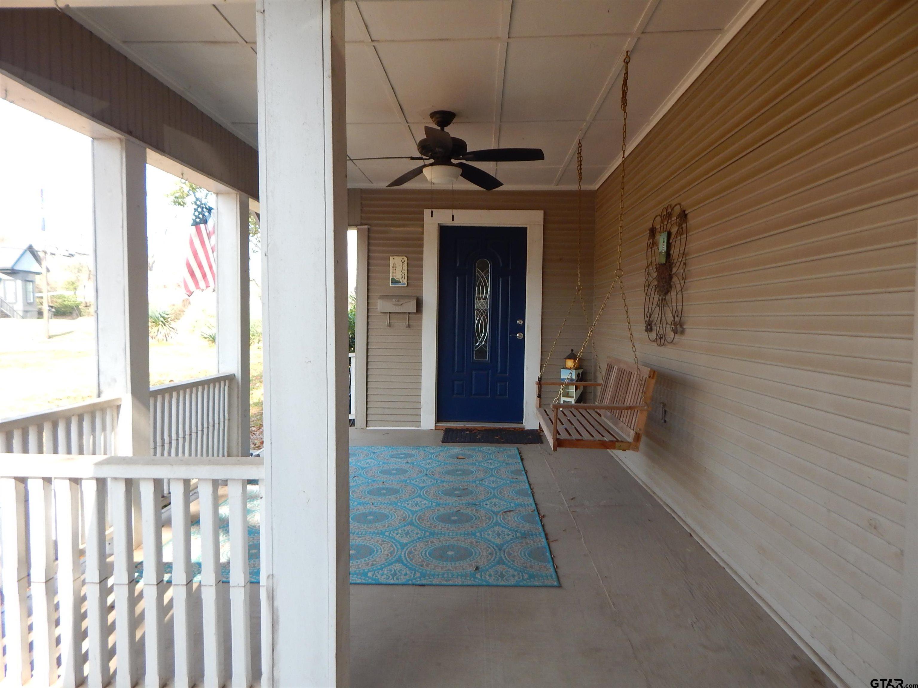 507 North Trinity Street Gilmer, TX 75644 - Photo 6 of 45 a view of a porch with a table and chairs