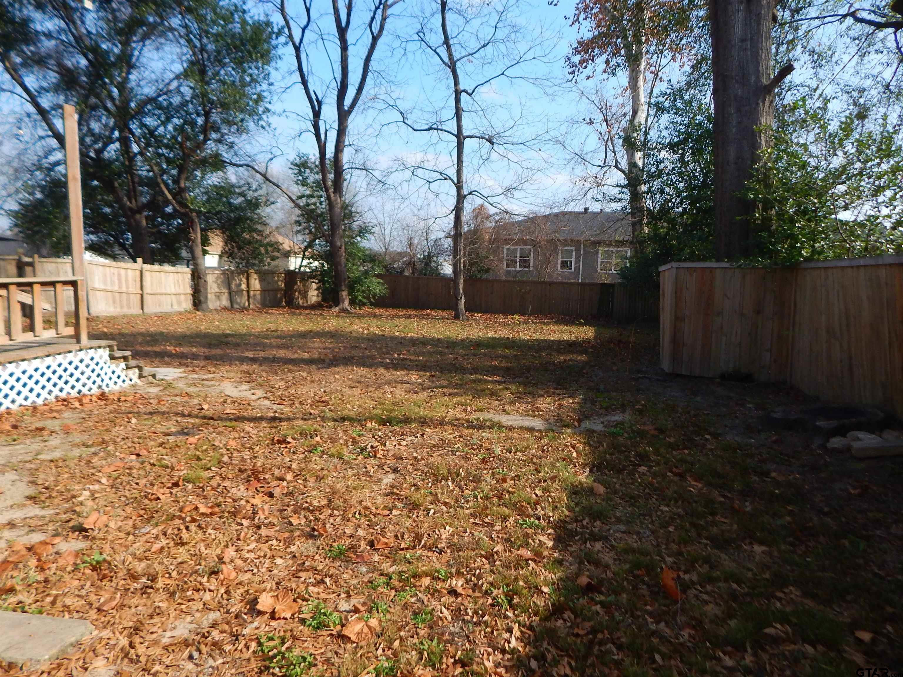 507 North Trinity Street Gilmer, TX 75644 - Photo 8 of 45 a view of a yard with large trees