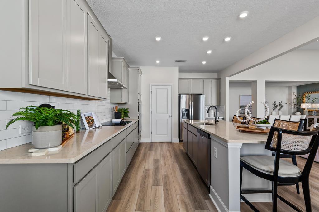 60 Pegasus Road Flagler Beach, FL 32136 - Photo 31 of 51 a kitchen with kitchen island granite countertop lots of counter top space and wooden floor