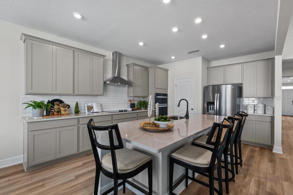 60 Pegasus Road Flagler Beach, FL 32136 - Photo 32 of 51 a kitchen with stainless steel appliances granite countertop a dining table chairs and refrigerator
