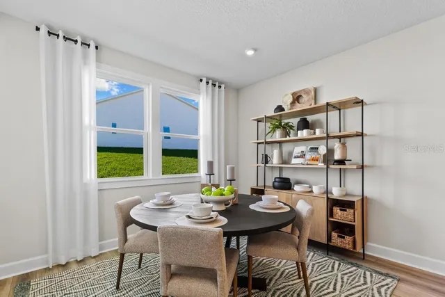 a view of a dining room with furniture window and wooden floor