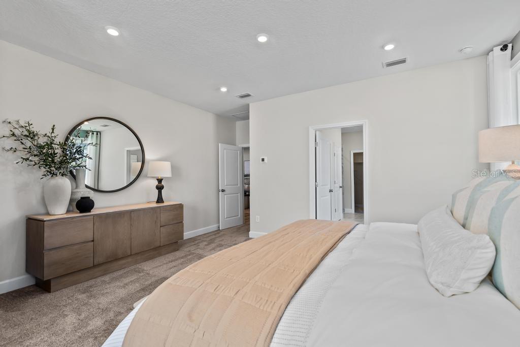 60 Pegasus Road Flagler Beach, FL 32136 - Photo 41 of 51 a bedroom with bed and a mirror on the dresser