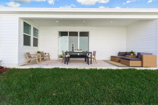a view of a patio with table and chairs