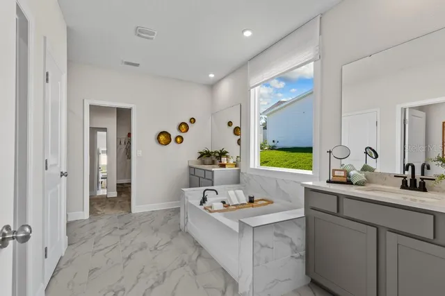 a kitchen with granite countertop a table chairs microwave and cabinets