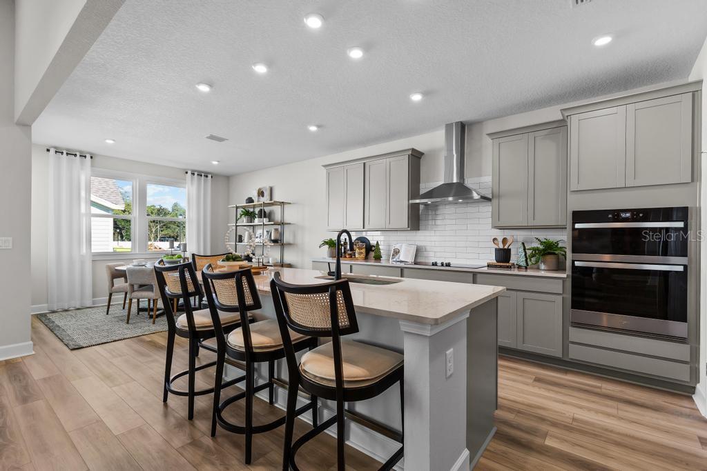 60 Pegasus Road Flagler Beach, FL 32136 - Photo 50 of 51 a kitchen with granite countertop a table chairs microwave and cabinets