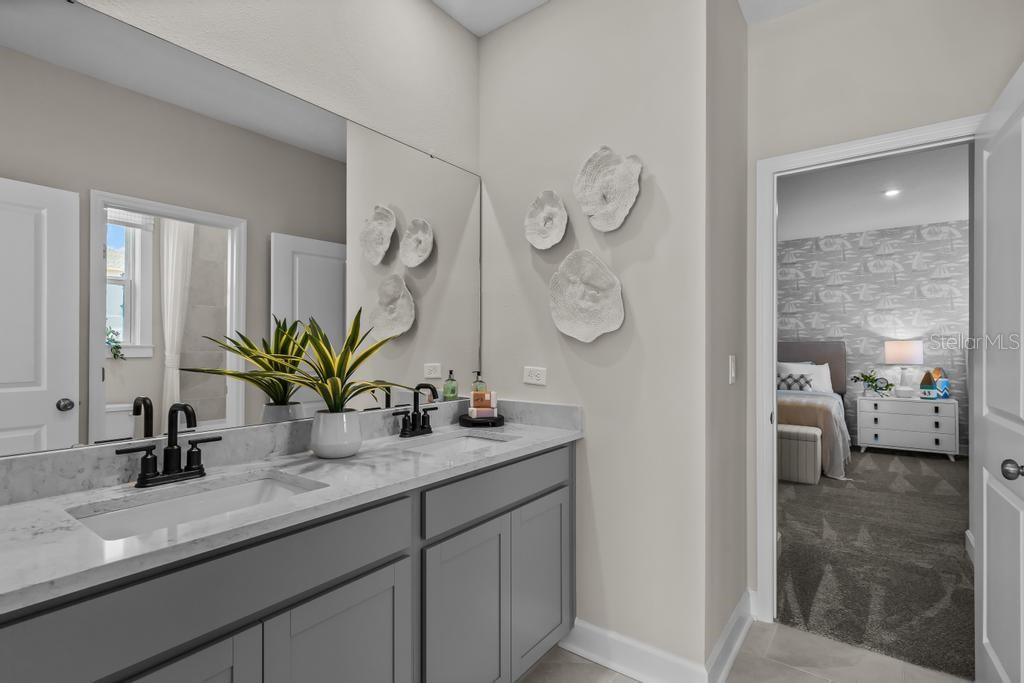 60 Pegasus Road Flagler Beach, FL 32136 - Photo 8 of 51 a en suite bathroom with a granite countertop sink and a mirror