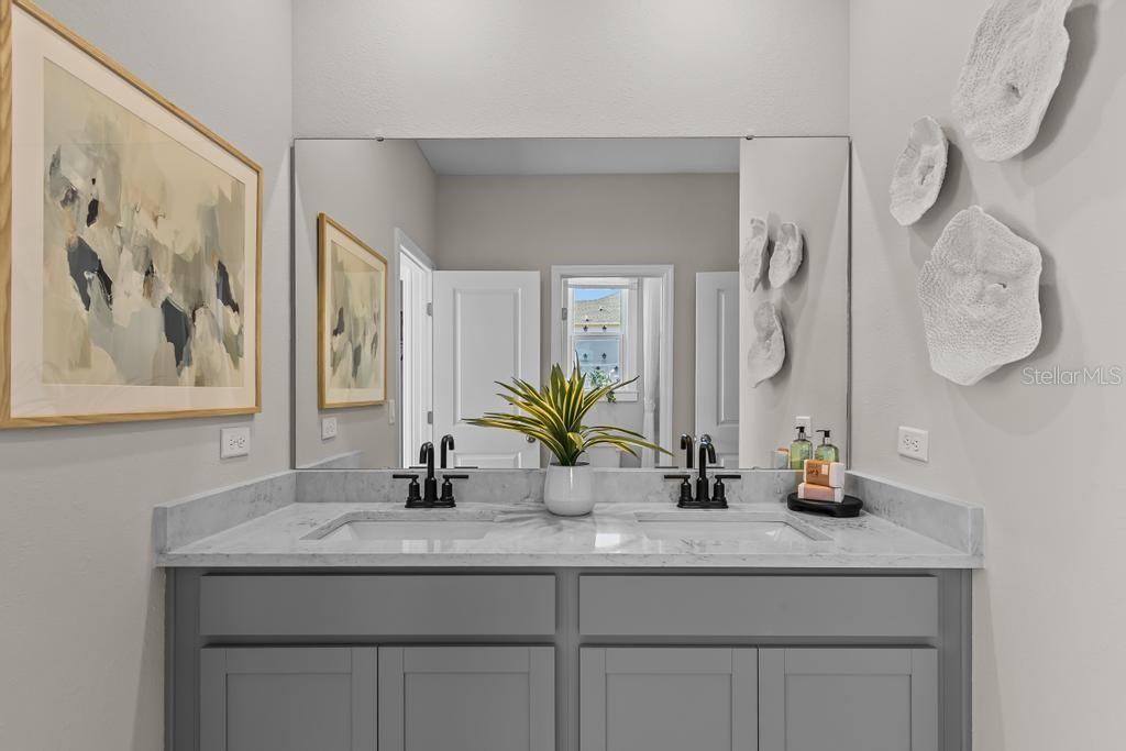 60 Pegasus Road Flagler Beach, FL 32136 - Photo 9 of 51 a bathroom with a granite countertop sink a mirror and vanity